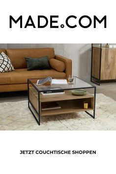 a living room with a brown couch and coffee table on top of carpeted floor