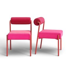 two pink chairs sitting next to each other on a white surface with no one in it