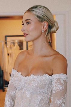 a woman wearing a wedding dress in a room