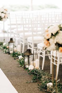 the aisle is lined with candles and flowers