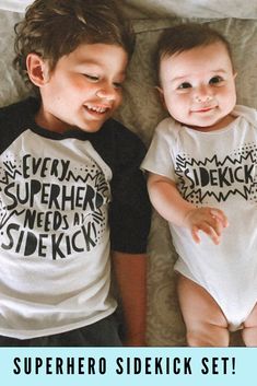 two babies laying next to each other on top of a white sheet with the caption superhero sideick set