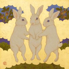 two white rabbits standing next to each other in front of a blue and yellow background