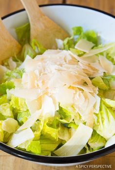 a white bowl filled with lettuce and cheese