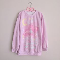 If you love soft pastel shades, comfy sweaters and bunnies, this is for you! A cute chibi bunny girl, dreamily floating on some soft clouds with the words 'sweet dream' below her. Sleeve illustrations include pastel yellow stars and cute white bunnies.  Back of the sweater reads 'good night' 86% Polyester, 14% Cotton Ships from the USA. Pink Crew Neck Top With Bunny Design, Cute Long Sleeve Sleep Tops, Pink Unicorn Print Long Sleeve Top, Pink Long Sleeve Top With Unicorn Print, Pink Long Sleeve Tops With Unicorn Print, Cute Pink Top With Bunny Print, Cute Pink Tops With Bunny Print, Cute Sleep Tops With Cartoon Print, Cute Pink Bunny Print Tops