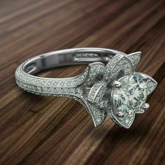 a diamond ring on top of a wooden table with diamonds around it and in the center