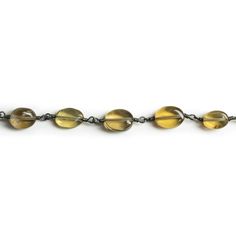 Beads measure about 8x6mm with roughly 24 beads per foot of chain. These lovely pieces show off a rich whiskey yellow color palette that pairs excellently with our signature black gold handwrapped chain. Expect sleek oval shapes that will lay great in necklaces and make for delightful dangling earrings. Spice up your next round of Jewelry Designs with specially curated Whiskey Quartz Ovals on our Black Gold plated chain!