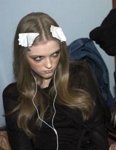 a woman with long hair and headphones on