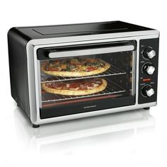 two pizzas are cooking in an oven