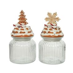 two glass jars with christmas decorations in them