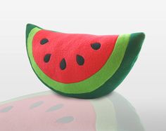 a watermelon pillow sitting on top of a table