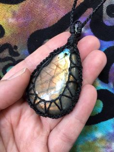 Made with durable linhasita cord, which is a waxed, polyester cord from Brazil! Features a beautiful, polished Multicolored Labradorite cabochon that measures about 2 1/2 inches long. Necklace cords are approximately 20 inches long. I recommend keeping your jewelry out of water and other corrosive elements to help it last longer! Have a question? Message me! Crochet Crystal Necklace, Crystal Necklace Diy, Macrame Crystal Necklace, Crystal Holder, Hemp Jewelry, Fiber Jewelry, Micro Macramé, Stone Wrapping, Crystal Crafts