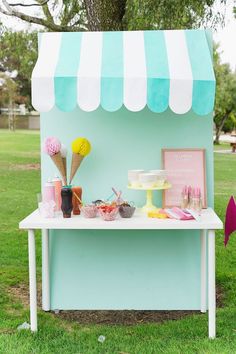 an ice cream stand is set up in the grass