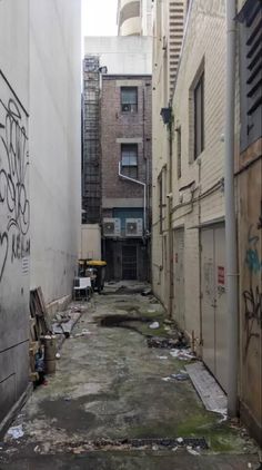 an alley way with graffiti on the walls