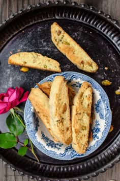 two pieces of bread on a plate next to flowers