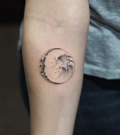 a small wave tattoo on the arm