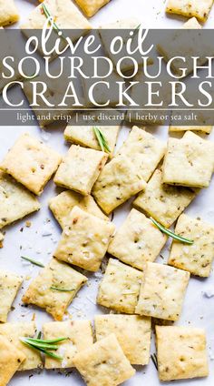 crackers with rosemary sprigs on top and text overlay that reads olive oil sourdough crackers