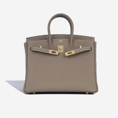 The Hermès Birkin is among the most famous bags in the world. First created in 1983 after Jean-Louis Dumas met Jane Birkin on a flight from Paris to London. In the short flight, Birkin explained that she needed a bag which was spacious enough for everything she needed to carry, with plenty of pockets as well. He sketched the first bag there and then, and the rest is history. More than thirty years later, this bag has been created in a huge variety of styles and materials. SPL Exterior Etoupe Togo Leather Gold-tone hardware Hermès logo stamp Two rolled leather handles Twist lock close Protective feet U code - 2022 Production Brand New condition Interior Matching interior Single compartment Zip pocket Slip pocket Brand new condition Sold with box, dust bag and lock & keys SPL Height 19cm Wid