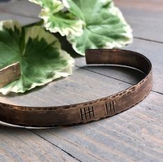 Personalized tally mark bracelet is the perfect gift for your special day! High quality bangle comes in your choice of weathered copper (8th anniversary), brushed aluminum (10th), or bronze (7th and 29th). Edges are hand hammered for a custom, finished look. Inside may be stamped with initials and heart ampersand. Short message may be substituted and options will be found in the drop downs. Bracelet With Initials, Stamped Dog Tags, Bronze Anniversary, Tally Marks, 8th Anniversary, 7th Anniversary, Anniversary Gifts For Wife, Brushed Aluminum, Bracelet Jewelry