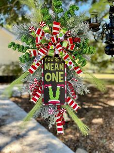 a christmas ornament hanging from the side of a tree