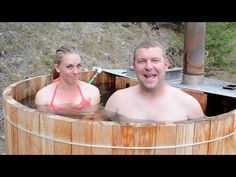 a man and woman in a wooden hot tub