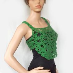 a mannequin wearing a green crochet top