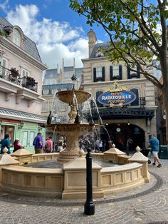 a fountain in the middle of a town square