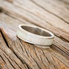 a wedding ring sitting on top of a wooden table