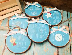 six hand painted wooden slices with sayings on them sitting on a blue wood plank