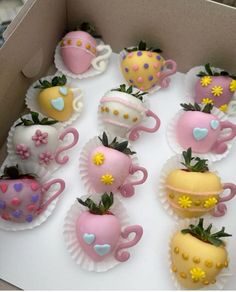 a box filled with chocolate covered strawberries and tea cups