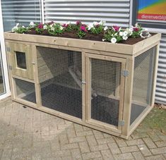 a large wooden planter with flowers growing out of it