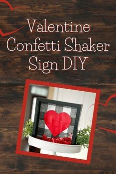 valentine's day sign diy with a red heart in the center on a wooden table