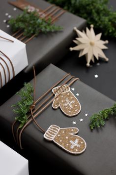 christmas presents wrapped in black paper with gold and white decorations