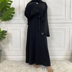 A modest wardrobe essential. Our IMAN dress is a timeless, classic piece. It can be worn beautifully both with or without a belt. This abaya is a loose fit which allows the high quality material to flow elegantly and gracefully. Including: A matching colored belt. Material: High-quality nidha fabric Elegant Belted Abaya, Modest Wardrobe, Wardrobe Essentials, Jewelry Sales, High Quality, Loose Fitting, Wardrobe, Beauty, Black