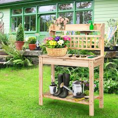 a potting bench with gardening tools and flowers