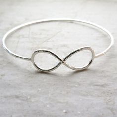 "Sterling Silver Infinity Bangle~ Beautiful sterling silver infinity symbol bangle, custom made for you! Hammered and polished for that extra sparkle! Looks great worn with one or more! Perfect gift for a friend or sweetheart. This listing is for a sterling silver hammered infinity symbol bangle like the one pictured, you choose the size and if you want 14 gauge or a thicker 12 gauge. Please view the last picture on this listing that shows how to measure for your correct size as there will be a Nickel-free Sterling Silver Bangle For Wedding, Sterling Silver Infinity Bracelets For Anniversary, Sterling Silver Infinity Bracelet For Anniversary, Adjustable Sterling Silver Bangle For Wedding, Silver Infinity Bracelet For Anniversary, Adjustable Silver Bangle For Bridesmaid Gift, Tahitian Pearl Ring, Hammered Bracelet, Bracelet Friendship