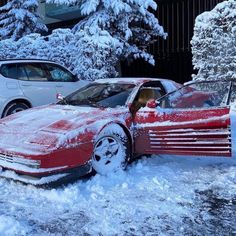 a red car that is sitting in the snow