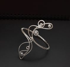 This arm cuff is versatile and perfect for a variety of occasions, always maintaining an elegant and spectacular appearance. Crafted from silver-plated wire, it features an exquisite wrapping of 8mm silver shell pearls. To ensure the perfect fit for your arm cuff, use a string or tape measure to determine the circumference of the area on your arm where you plan to wear the cuff. Wrap the string or tape around your arm, ensuring it sits comfortably but snugly, and note the measurement. If you req Wire Arm Cuff, Upper Arm Cuff Bracelet, Silver Arm Cuff, Upper Arm Cuff, Arm Cuff Bracelet, Upper Arm Cuffs, Beautiful Arms, Senior Prom, Arm Cuff