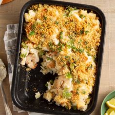 a casserole dish with shrimp, broccoli and cauliflower