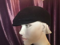 Well made original vintage hat crafted of 100% black wool felt. The small and subtle visor at the front provides the iconic 60s style popularized with Mod fashion. Somewhat of a beret style, though more substantial. Black grosgrain ribbon lines the interior. Unable to determine the maker on the faded label. Original 1960s style popularized during the Beat generation. A great look for artists, poets and musicians Circumference 22 inches circa 1960s Excellent vintage condition Lovingly and careful Classic Black Flat Cap Felt Hat, Formal Winter Cap Hat, Winter Formal Cap Hat, Formal Winter Cap, Black Fitted Flat Cap Felt Hat, Formal Winter Flat Cap Felt Hat, Formal Winter Felt Flat Cap, Formal Wool Flat Cap, Winter Formal Felt Flat Cap