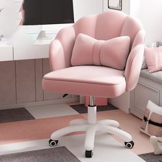 a pink office chair sitting in front of a computer monitor on top of a desk