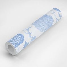 a roll of blue and white wallpaper with an elephant design on the bottom half