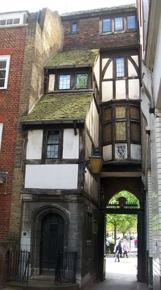 an old building with people walking down the street