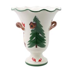 a white vase with green and brown designs on it's sides, decorated with trees