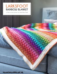 a colorful crocheted blanket sitting on top of a couch