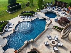 an aerial view of a swimming pool with lounge chairs and water fountain in the middle