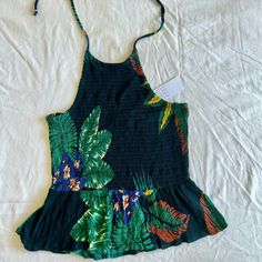 Brand New With Tags! Patrons Of Peace Peplum Style Halter Top In Their ‘Marine’ Tropical Print . Smocked Bodice With A Gauzy Over Skirt Attached At The Waistline. Excellent Condition, No Flaws! Brand: Patrons Of Peace Size: Medium Material: 100% Rayon Chest: 14”-19” Total Length: 19” *All Measurements Are Taken Flat With Fabric Measuring Tape. Fitted Cotton Tops With Tropical Print, Rayon Beach Tops For Beach Season, Fitted Tropical Beach Tops, Summer Halter Neck Top With Floral Print, Beach Season Rayon Tops, Fitted Vacation Top With Smocked Back, Green Tops With Smocked Back For Day Out, Chic Fitted Tops For Summer Outings, Spring Rayon Top With Tropical Print