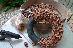 a bucket filled with lots of brown pipes next to a hammer and some other tools