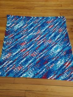 a blue and red rug sitting on top of a hard wood floor next to a wooden floor