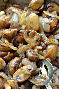 mushrooms and onions in a pan with a spoon