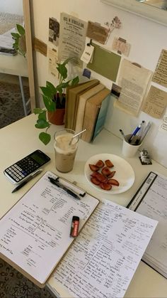 an office desk with papers, calculator and cell phone